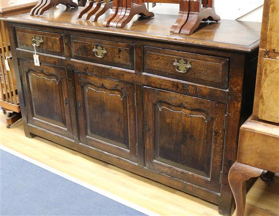 A 17th century style oak dresser base W.154cm